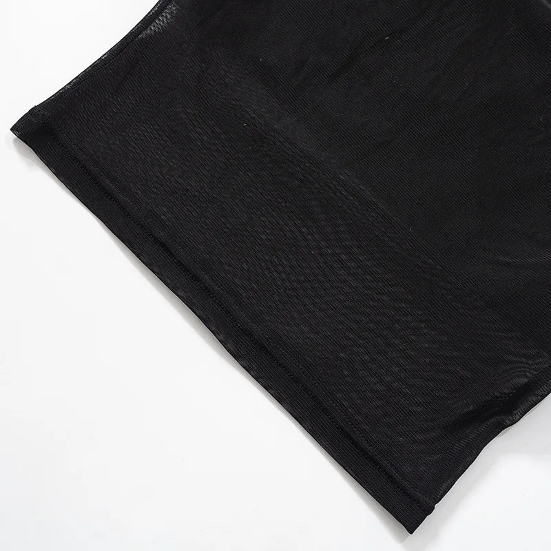 Black knit cropped top with patchwork details.